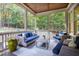 Relaxing screened porch featuring comfortable seating and beautiful views of the backyard at 3209 Bryant Falls Ct, Raleigh, NC 27613