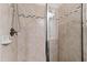 Detailed view of the shower with beige tiling and a decorative accent strip at 3209 Bryant Falls Ct, Raleigh, NC 27613
