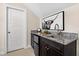 Attractive wet bar with dark wood cabinets, granite countertop, mini fridge and modern hardware at 3209 Bryant Falls Ct, Raleigh, NC 27613