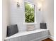 Bright window seat with shiplap accent wall, decorative pillows, and sconce lighting at 3209 Bryant Falls Ct, Raleigh, NC 27613