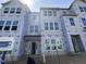 New construction townhome featuring large windows and modern architectural details at 327 Chesapeake Cmns St # 105, Garner, NC 27529