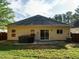 A backyard with green grass, a patio, and a hot tub, perfect for relaxing and entertaining outdoors at 33 Juliette Dr, Durham, NC 27713