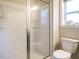 Bathroom featuring a walk-in shower with glass doors and a toilet with a white porcelain finish at 33 Juliette Dr, Durham, NC 27713
