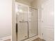 Bathroom featuring a glass-enclosed walk-in shower with a built-in seat and a convenient grab bar at 33 Juliette Dr, Durham, NC 27713