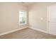 A cozy bedroom featuring neutral-toned walls, plush carpeting, and a window that allows natural light at 33 Juliette Dr, Durham, NC 27713
