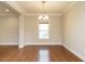 Open dining area with hardwood floors, crown molding, and a chandelier providing a warm ambiance at 33 Juliette Dr, Durham, NC 27713