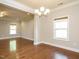 Open dining area with hardwood floors, crown molding, and a chandelier providing a warm ambiance at 33 Juliette Dr, Durham, NC 27713