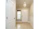 Inviting foyer featuring tile flooring, a decorative chandelier and a neutral color palette at 33 Juliette Dr, Durham, NC 27713