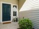 Cozy front entrance with a dark teal door, a welcoming doormat and decorative potted plants at 33 Juliette Dr, Durham, NC 27713