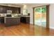 Open concept kitchen featuring dark wood cabinets, granite countertops, and a large center island with sliding glass doors at 33 Juliette Dr, Durham, NC 27713