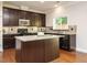 Updated kitchen with granite countertops, dark cabinetry, stainless appliances, and an island, perfect for entertaining at 33 Juliette Dr, Durham, NC 27713