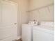 A dedicated laundry room featuring a washer and dryer set and a wire shelf for storage solutions at 33 Juliette Dr, Durham, NC 27713
