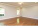 Spacious living room featuring hardwood floors, crown molding, and large windows, offering plenty of natural light at 33 Juliette Dr, Durham, NC 27713