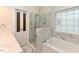 Beautiful bathroom featuring a glass shower, soaking tub, and marble tile accents at 3339 Archdale Dr, Raleigh, NC 27614