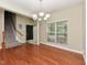 Bright dining room with hardwood floors, a chandelier, and large windows provides a welcoming atmosphere at 3339 Archdale Dr, Raleigh, NC 27614