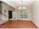 View of the home's entry showing hardwood floors, a chandelier, and natural light from the windows at 3339 Archdale Dr, Raleigh, NC 27614