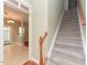 Entryway with stairway leading to upper level and an open doorway to the living space at 3339 Archdale Dr, Raleigh, NC 27614