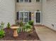 Cozy front entrance features a small seating area surrounded by well-maintained landscaping at 3339 Archdale Dr, Raleigh, NC 27614