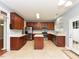 Bright kitchen with stainless steel appliances, wooden cabinets, and a convenient center island at 3339 Archdale Dr, Raleigh, NC 27614