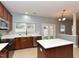 Modern kitchen with stainless steel appliances, a center island, and lots of natural light at 3339 Archdale Dr, Raleigh, NC 27614