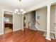 Open-concept living room featuring hardwood floors, a staircase, and an adjacent kitchen at 3339 Archdale Dr, Raleigh, NC 27614