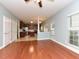 Bright living room with hardwood floors and large windows transitions smoothly to the home's kitchen at 3339 Archdale Dr, Raleigh, NC 27614