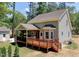 View of the rear of the house with its large wooden deck and screened in porch at 3357 Denise St, Durham, NC 27704