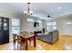 Open-concept living area with hardwood floors, a dining table, and a comfortable seating area at 3357 Denise St, Durham, NC 27704