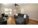 Cozy living room with hardwood floors, a gray sectional, and plenty of natural light at 3357 Denise St, Durham, NC 27704