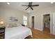 Bright main bedroom features a ceiling fan, hardwood floors, and a walk-in closet at 3357 Denise St, Durham, NC 27704