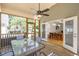 Inviting screened porch with glass table and chairs, perfect for outdoor enjoyment and relaxation at 3357 Denise St, Durham, NC 27704