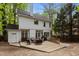 This backyard has outdoor seating with a large wood deck, white exterior elevation, and a treelined privacy fence at 3401 Scotch Dr, Raleigh, NC 27616