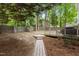 This backyard has a treelined privacy fence, grill, and a stone tile walkway at 3401 Scotch Dr, Raleigh, NC 27616
