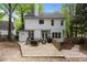 This backyard has outdoor seating with a large wood deck, white exterior elevation, and a treelined privacy fence at 3401 Scotch Dr, Raleigh, NC 27616