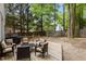 This backyard has outdoor seating with a large wood deck, grill, and treelined privacy fence at 3401 Scotch Dr, Raleigh, NC 27616