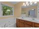 This bathroom features a soaking tub, double vanity, and a window that provides natural light at 3401 Scotch Dr, Raleigh, NC 27616