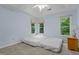 Tranquil bedroom with a ceiling fan, carpet, and natural light from multiple windows at 3401 Scotch Dr, Raleigh, NC 27616