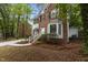 Charming brick and white home with lush landscaping and a welcoming front entrance at 3401 Scotch Dr, Raleigh, NC 27616
