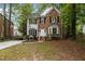Charming two-story home with a well-manicured front yard, brick facade, and welcoming entrance at 3401 Scotch Dr, Raleigh, NC 27616