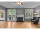 Bright living room with hardwood floors, fireplace, natural light, and neutral gray color palette at 3401 Scotch Dr, Raleigh, NC 27616