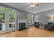 Comfortable living room with a fireplace, grey walls, hardwood floors, and access to a deck at 3401 Scotch Dr, Raleigh, NC 27616
