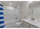Well-lit bathroom with a shower-tub combo, white vanity, and tile flooring at 36 High View Ct, Fuquay Varina, NC 27526