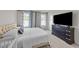 Cozy bedroom with a large bed, dark wood dresser, and two windows for natural light at 36 High View Ct, Fuquay Varina, NC 27526