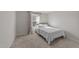 Carpeted bedroom features a large bed, neutral walls, and a window with patterned curtains at 36 High View Ct, Fuquay Varina, NC 27526