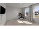 Bright bedroom with a desk area, large windows, and neutral carpet at 36 High View Ct, Fuquay Varina, NC 27526