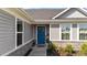 Charming exterior shot of a home entrance with blue door and stone accents at 36 High View Ct, Fuquay Varina, NC 27526