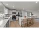 Modern kitchen with white cabinets, stainless steel appliances, a large kitchen island, and three bar stools at 36 High View Ct, Fuquay Varina, NC 27526