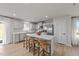 Bright kitchen featuring white cabinets, a stainless steel fridge, and large island with bar stool seating at 36 High View Ct, Fuquay Varina, NC 27526