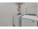 Laundry room with a modern washing machine and dryer, plus storage shelf at 36 High View Ct, Fuquay Varina, NC 27526