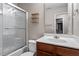 Bathroom with walk-in shower, single vanity, and wood cabinets at 4007 Newell Ln, Raleigh, NC 27616